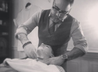 Dino, giving his nephew his first straight razor shave in his barber shop.