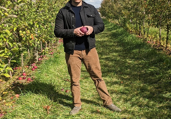 Man standing in an apple orchard