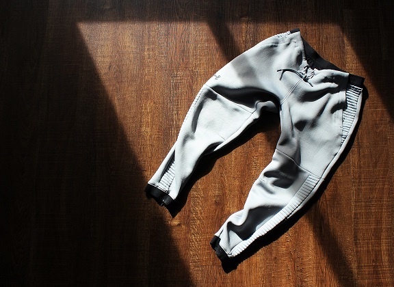 Athletic pants on the floor in sunlight