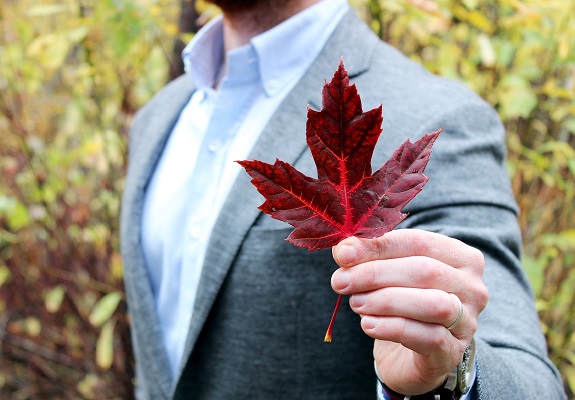 man holding red leaf