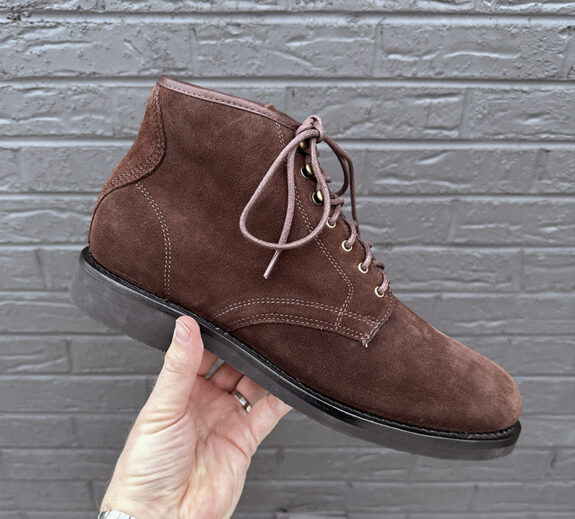 Hand holding J. Crew Field Boots in Brown Suede