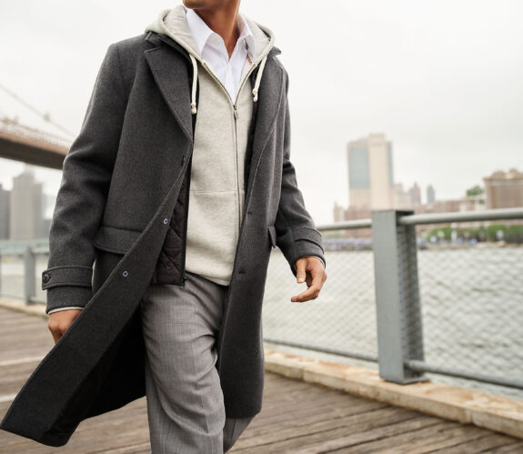 Man at waterfront wearing top coat