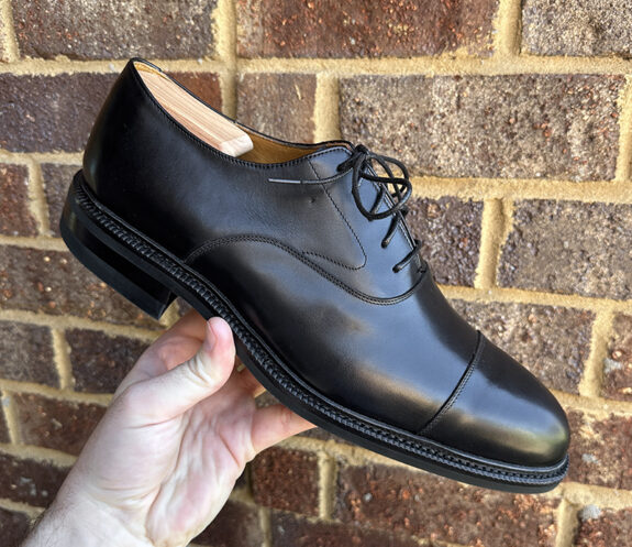 Meermin Cap Toe Oxfords being held by man's hand